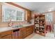 Bright kitchen features double sink, wood cabinets, and ample counter space at 2028 Coker Ave, Charleston, SC 29412