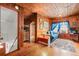 Upstairs loft area with wood walls, a couch, and a TV at 2028 Coker Ave, Charleston, SC 29412