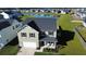 Two-story house with a gray roof and white garage, situated on a landscaped lawn near a pond at 268 Lucca Dr, Summerville, SC 29486