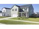 Two-story house with gray siding, white garage, and a landscaped front yard at 268 Lucca Dr, Summerville, SC 29486