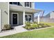 Two-story house with gray siding, white garage, and a landscaped front porch at 268 Lucca Dr, Summerville, SC 29486
