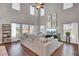 Spacious living room featuring hardwood floors, a beige sofa, and a large TV at 268 Lucca Dr, Summerville, SC 29486