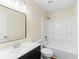 Clean bathroom with a white tub/shower combo, dark vanity, and a large mirror at 444 Longleaf Dr, Summerville, SC 29483