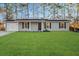 Ranch style home with gray siding, solar panels, and a manicured lawn at 444 Longleaf Dr, Summerville, SC 29483