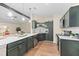 Modern kitchen with dark green cabinets, quartz countertops, and stainless steel appliances at 444 Longleaf Dr, Summerville, SC 29483