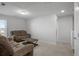 Bright bonus room with two brown reclining sofas and a wood coffee table at 467 Eagleview Drive, Moncks Corner, SC 29461