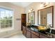 Double vanity bathroom with granite countertop and window at 4712 Westervelt Rd, Meggett, SC 29449