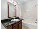 Bathroom with dark vanity and a tub shower combo at 4712 Westervelt Rd, Meggett, SC 29449