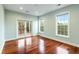 Bedroom with hardwood floors, windows and door to deck at 4712 Westervelt Rd, Meggett, SC 29449