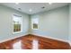 Light and airy bedroom with hardwood floors and two windows at 4712 Westervelt Rd, Meggett, SC 29449