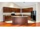 Kitchen with dark wood cabinets, granite countertops, and an island at 4712 Westervelt Rd, Meggett, SC 29449