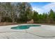 Kidney shaped pool with concrete decking at 4712 Westervelt Rd, Meggett, SC 29449