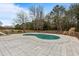 Relaxing kidney-shaped pool with surrounding patio at 4712 Westervelt Rd, Meggett, SC 29449