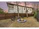 Fire pit area with seating in a fenced backyard at 79 Sandbar Ln, Folly Beach, SC 29439