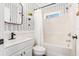 Stylish bathroom with white vanity, herringbone wallpaper, and tub at 79 Sandbar Ln, Folly Beach, SC 29439