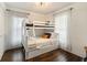 Bedroom with bunk beds, hardwood floors and plenty of light at 79 Sandbar Ln, Folly Beach, SC 29439