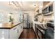Stainless steel appliances and white cabinetry in open kitchen at 79 Sandbar Ln, Folly Beach, SC 29439
