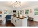Open concept kitchen with island and living area view at 79 Sandbar Ln, Folly Beach, SC 29439