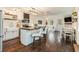 Modern kitchen with white cabinets, island, and dark hardwood floors at 79 Sandbar Ln, Folly Beach, SC 29439