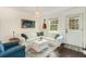Cozy living room with white couch and dark hardwood floors at 79 Sandbar Ln, Folly Beach, SC 29439