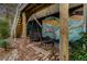 Relaxing patio with hanging chairs and artistic wall mural at 79 Sandbar Ln, Folly Beach, SC 29439