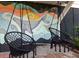Two hanging chairs in front of a whale mural at 79 Sandbar Ln, Folly Beach, SC 29439