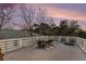 Relaxing rooftop deck with dining table, chairs, and string lights at 79 Sandbar Ln, Folly Beach, SC 29439
