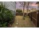 Landscaped side yard with stone path and bench at 79 Sandbar Ln, Folly Beach, SC 29439