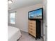 Bright bedroom with dresser and large TV at 8700 Forte Dr, North Charleston, SC 29406