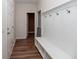 A hallway with white wainscoting, built-in bench, and hardwood floors at 8700 Forte Dr, North Charleston, SC 29406