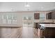 Modern kitchen with dark cabinets, quartz countertops, and stainless steel appliances at 8700 Forte Dr, North Charleston, SC 29406