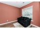 Cozy office with terracotta walls, a black couch, and a large window at 8700 Forte Dr, North Charleston, SC 29406