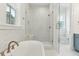 Elegant bathroom boasts a soaking tub, glass-enclosed shower with marble tile, and stylish fixtures at 9005 Stern Aly, Johns Island, SC 29455