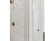 Close up of a glass enclosed shower with bronze fixtures and white marble tiling at 9005 Stern Aly, Johns Island, SC 29455