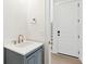 Stylish bathroom featuring vanity with blue cabinets and brass fixtures at 9005 Stern Aly, Johns Island, SC 29455