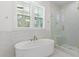 Elegant bathroom featuring a freestanding tub and glass-enclosed shower at 9005 Stern Aly, Johns Island, SC 29455