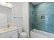 Stylish bathroom with blue tiled shower and white vanity, and modern fixtures at 9005 Stern Aly, Johns Island, SC 29455