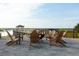 Firepit with wooden chairs on a sandy area overlooking marsh at 9005 Stern Aly, Johns Island, SC 29455
