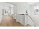 Bright hallway with hardwood floors, white banister, and natural light from multiple windows at 9005 Stern Aly, Johns Island, SC 29455