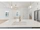 View of a bright kitchen with a large island and modern lighting fixtures, looking into the living area at 9005 Stern Aly, Johns Island, SC 29455