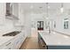 Gourmet kitchen featuring stainless appliances, white cabinetry, gas range and views to the living area at 9005 Stern Aly, Johns Island, SC 29455