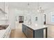 Bright kitchen with a large island, gas range, and hardwood flooring is adjacent to the living room at 9005 Stern Aly, Johns Island, SC 29455