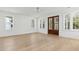 Bright living room featuring hardwood floors, white walls, and exterior double doors at 9005 Stern Aly, Johns Island, SC 29455