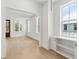 Bright living room with hardwood floors, white trim, built in shelving and lots of windows at 9005 Stern Aly, Johns Island, SC 29455