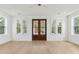 Bright living room featuring hardwood floors, white walls, and exterior double doors at 9005 Stern Aly, Johns Island, SC 29455