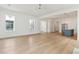 Spacious living room with hardwood floors, large windows, and an open layout to the kitchen at 9005 Stern Aly, Johns Island, SC 29455