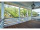 Inviting porch with wood floors, white railings and posts, and a lantern light fixture at 9005 Stern Aly, Johns Island, SC 29455