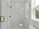 Bright white shower with subway tile, glass door, and bronze fixtures at 9005 Stern Aly, Johns Island, SC 29455