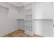 Spacious walk-in closet with custom shelving, wooden rods, and wood flooring at 9005 Stern Aly, Johns Island, SC 29455