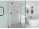 Bright bathroom showcasing a glass-enclosed shower and freestanding tub with marble tiling at 9009 Stern Aly, Johns Island, SC 29455